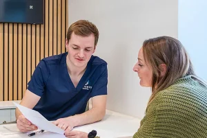 Dentist discussing Invisalign cost and treatment options with a patient.